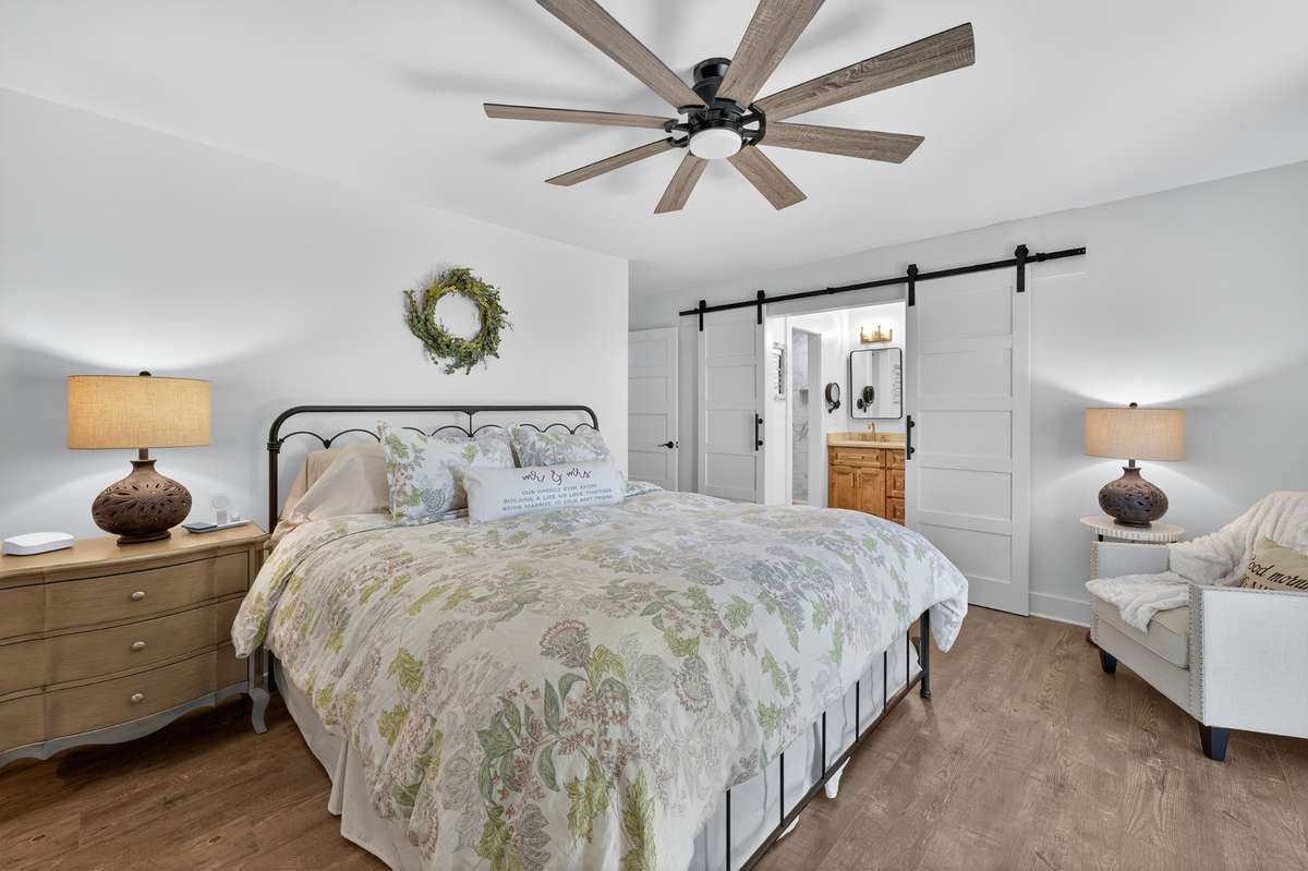 Freshly painted and ready for you to move in! The sliding barn doors lead you to the primary bathroom and one of the closets.