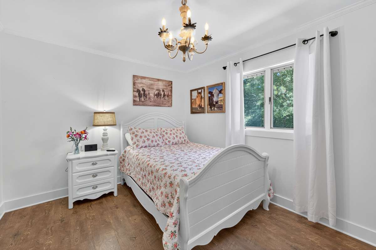 Secondary bedroom has new engineered wood flooring, 2 closets and a view of the front yard that doesn't disappoint.