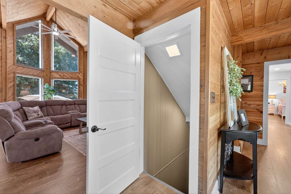 Doorway leading to the finished basement has an automatic light and carpeted steps.