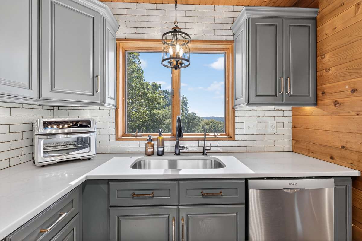 Single basin stainless steel sink makes cleaning larger items a breeze! The smaller faucet is a reverse osmosis water dispenser which conveys with the home. The whole house has a Rain Soft water softener system which also conveys.