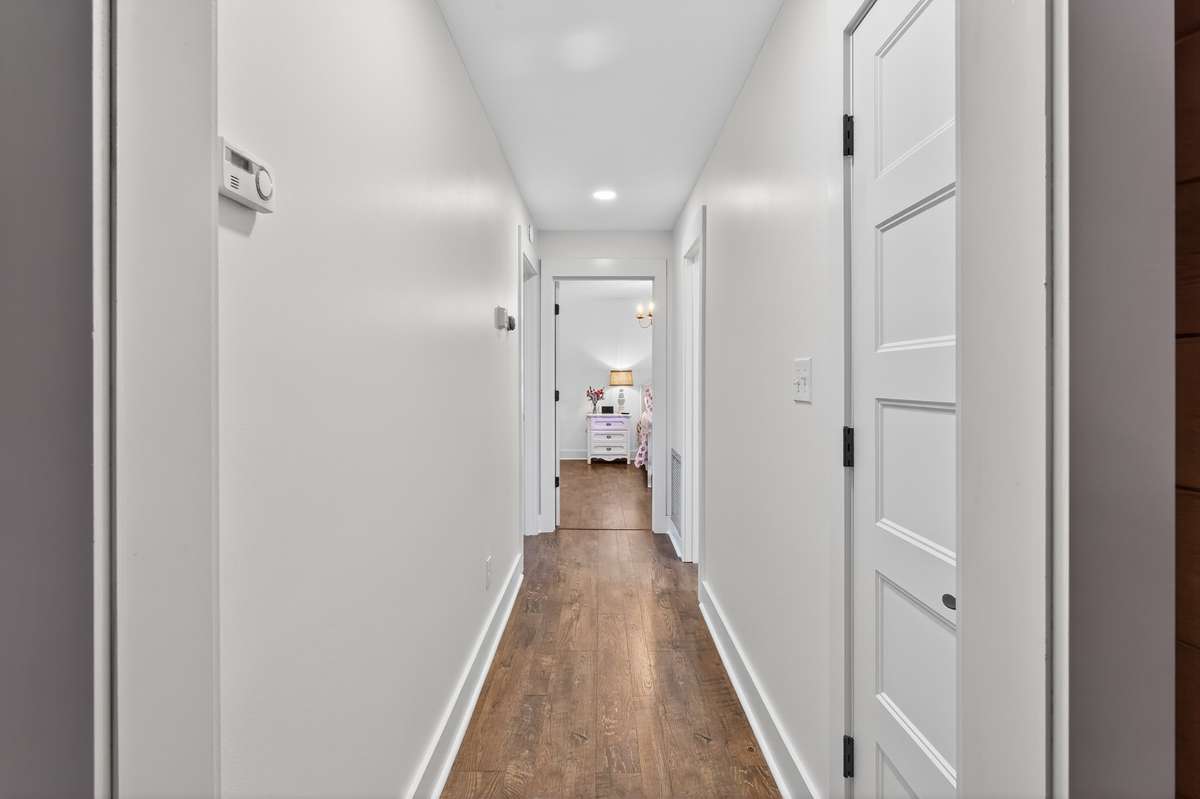 Hallway leading to the primary bedroom, secondary bedroom and hall bath.