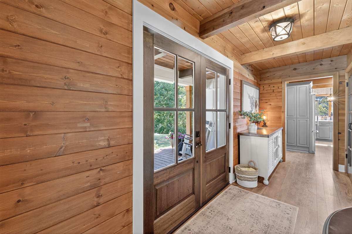 Beautiful mahogany double front doors with 4 light panels, stained in a rich brown.
