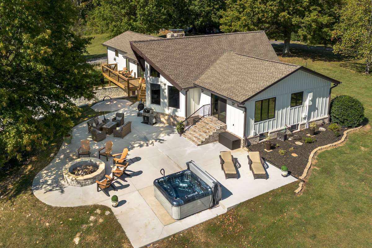 New concrete patio lines the back yard for years of entertaining. Relax by the fire pit or enjoy an evening in the hot tub.