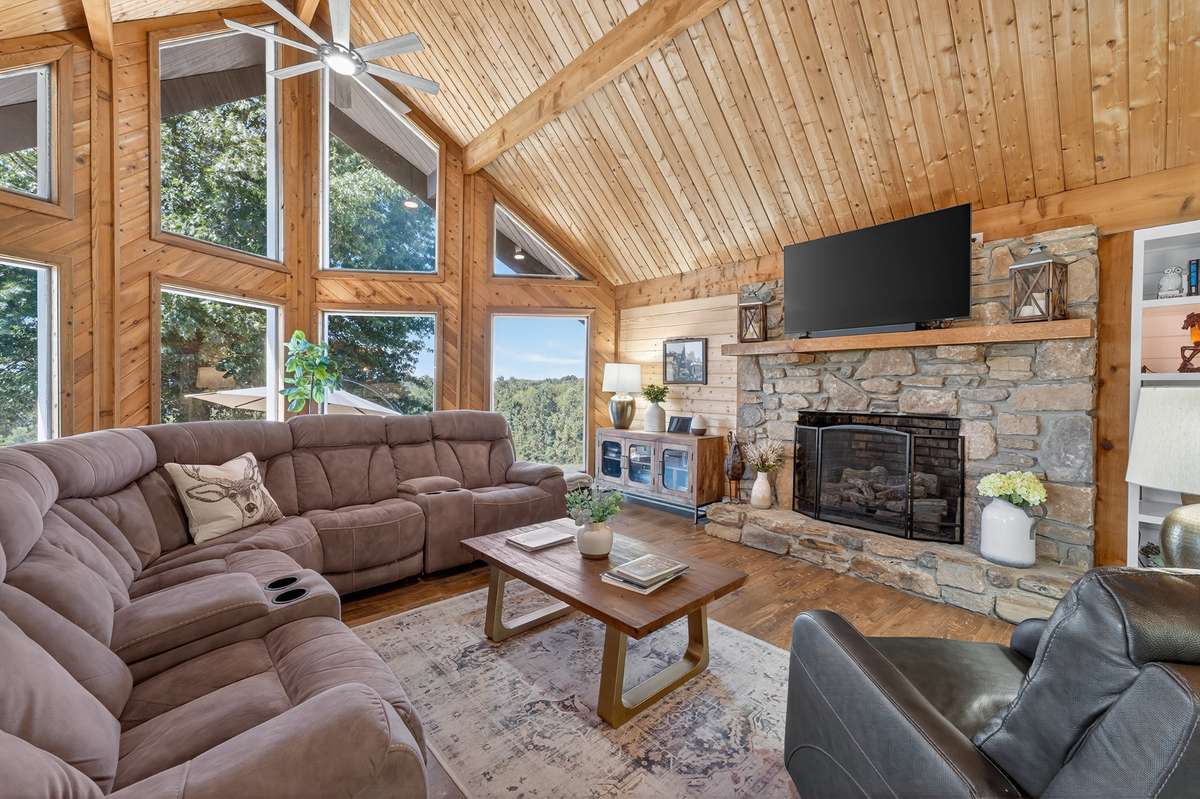 The stone fireplace on this level is a gas fireplace. Additional fireplace in the basement that is wood burning. The wood walls and ceiling really speak to the Tennessee style home.
