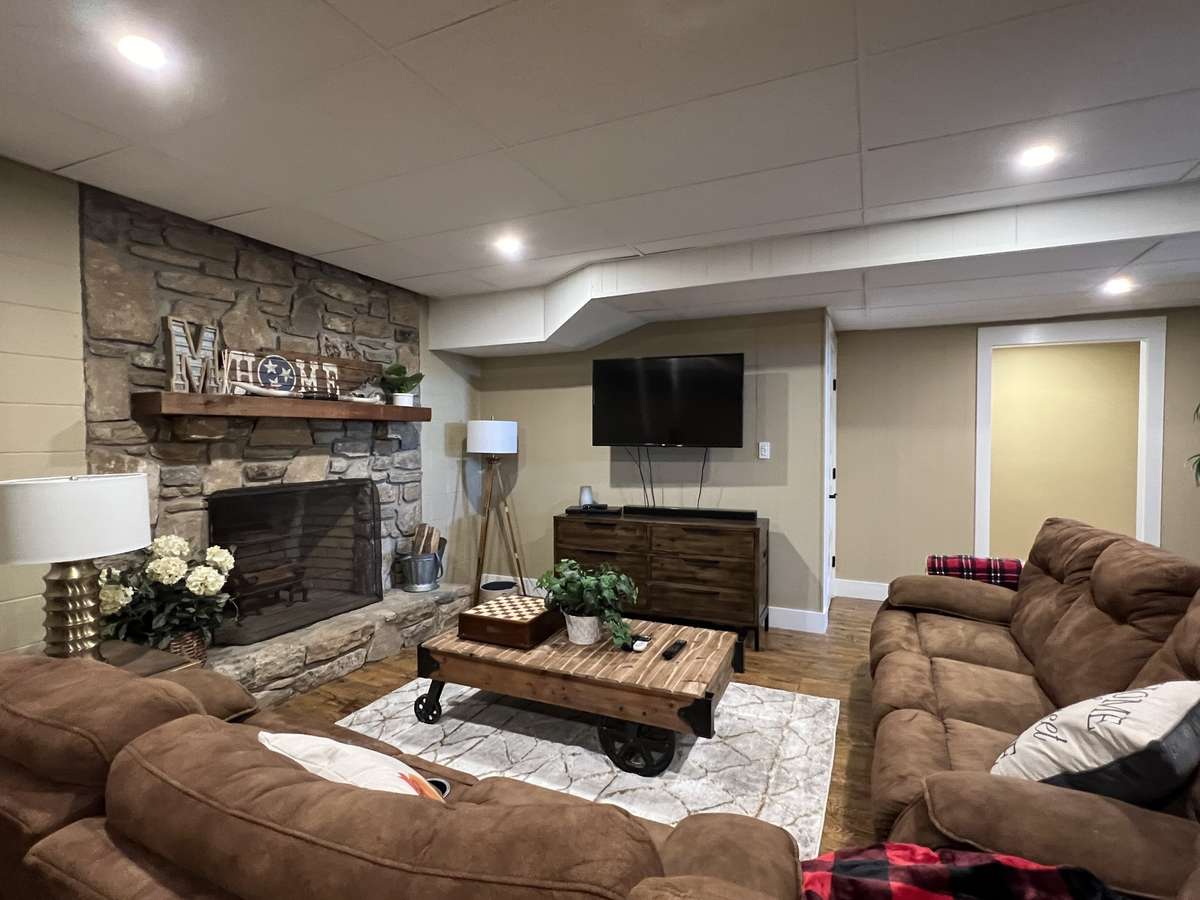 Additional family room in the basement features a wood burning fireplace (which we have never used) with an original stone hearth and surround and wood mantle. Basement has sealed walls with a perimeter drain system installed by AHS (with warranty).