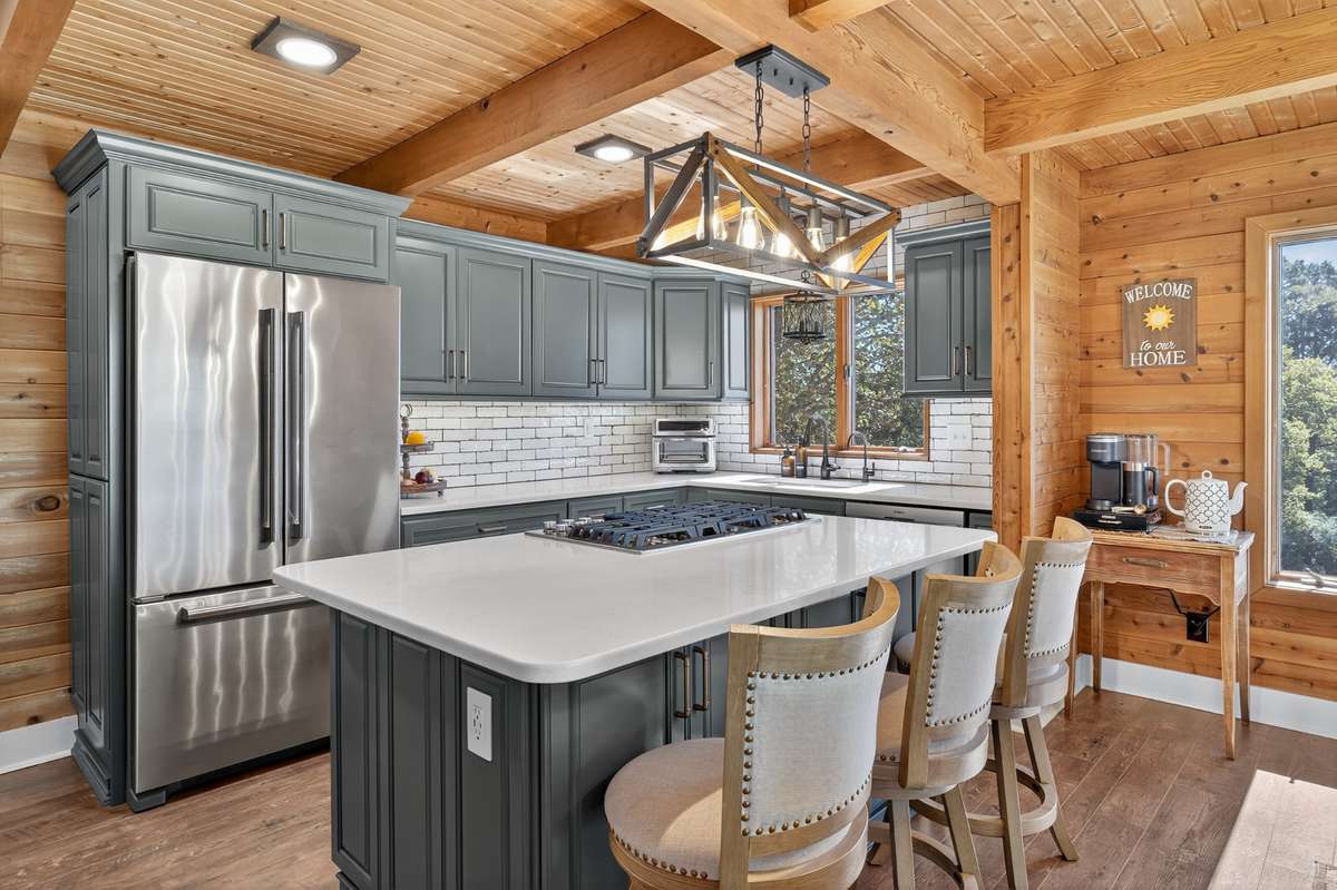 Enjoy cooking on your JennAir gas cooktop with a downdraft system. This is the heart of the home! Refrigerator can remain and is a counter depth JennAir fridge.