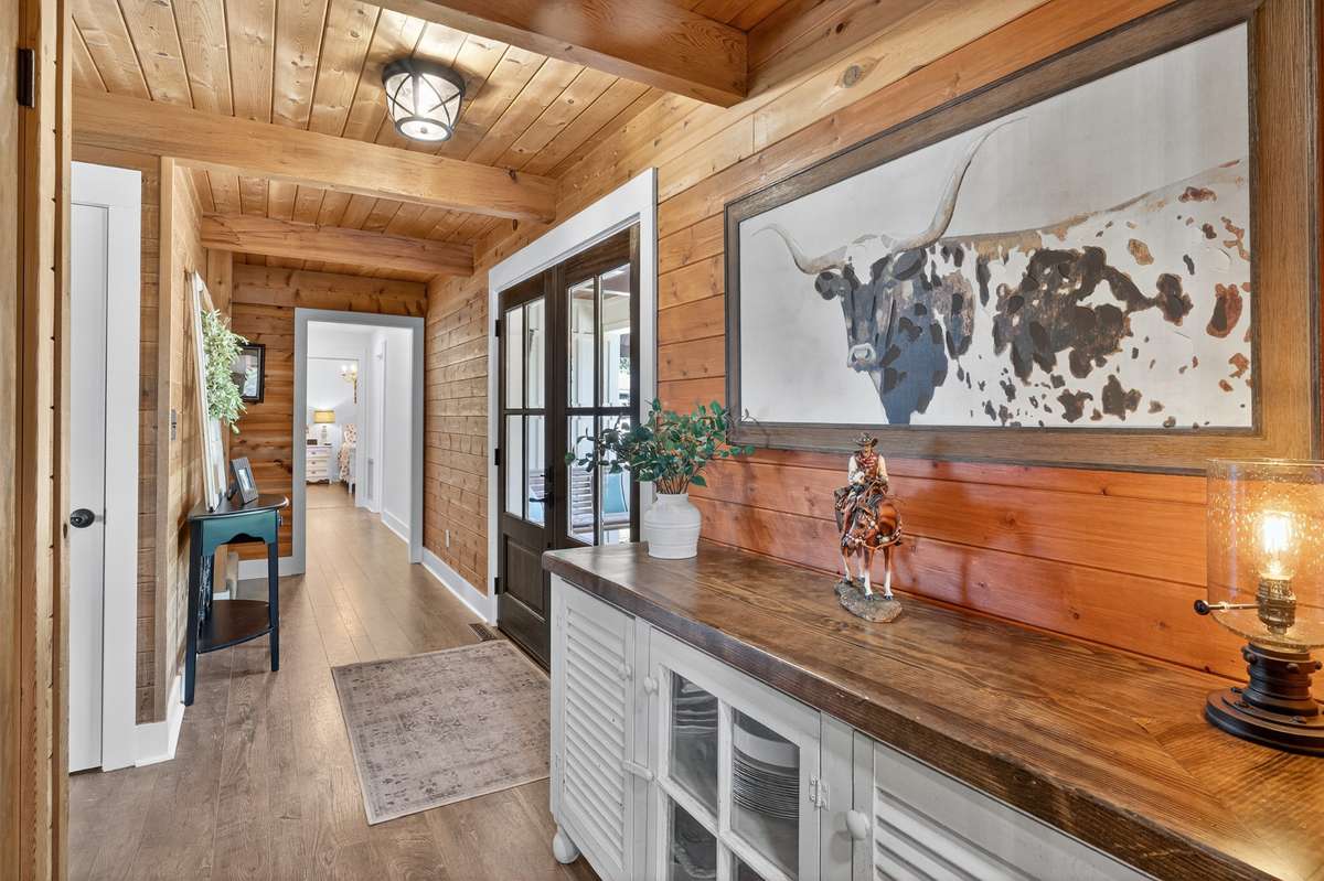 Hallway leads to the loft, 2 main level bedrooms and 2 bathrooms. Primary bedroom is on the main level.