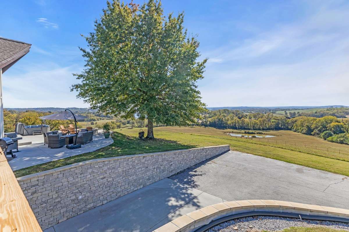 Gorgeous mature trees throughout the property. This back driveway leads to the finished basement and basement garage.