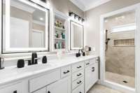 Primary bath with duel vanities and a custom tile shower