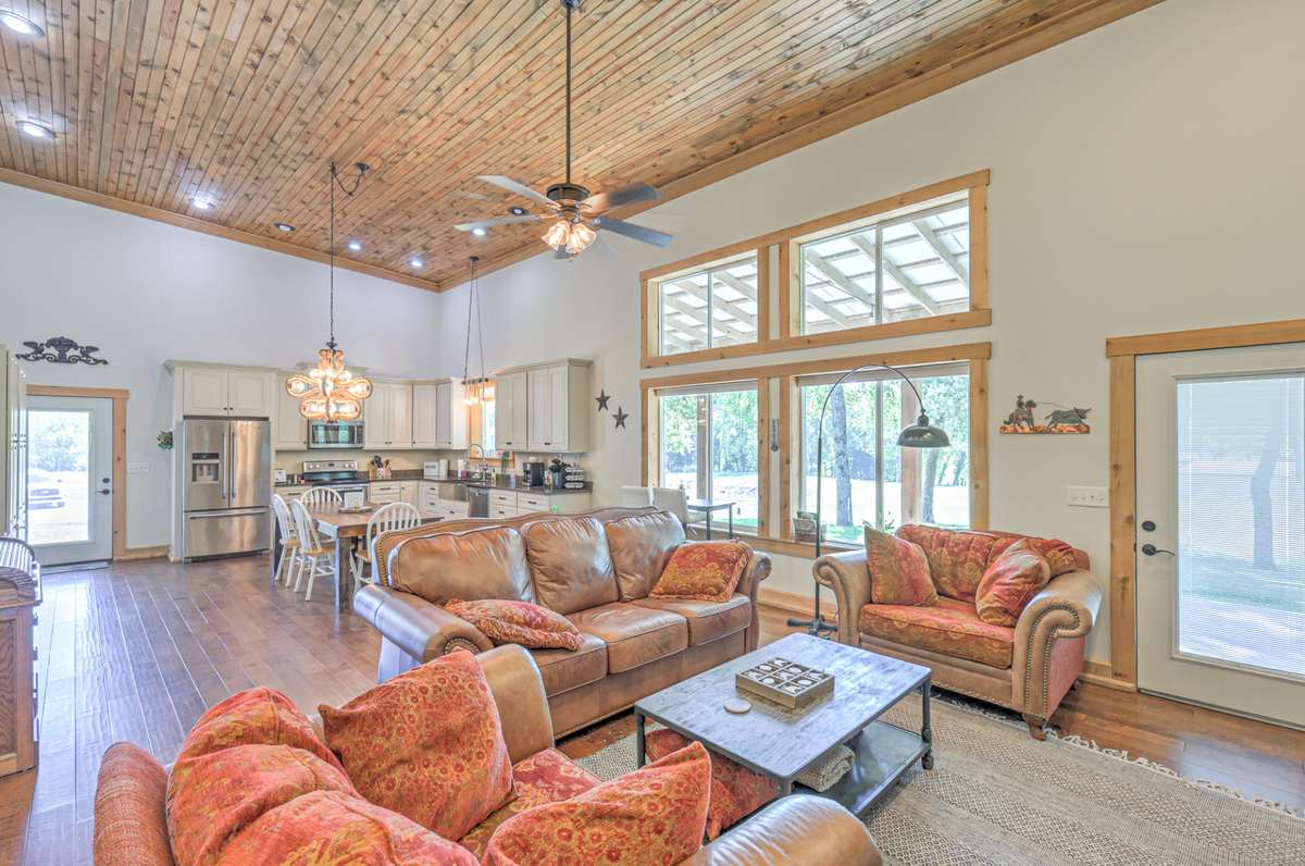 Open floor plan with lots of windows, exterior doors to the wrap around porch and hardwood flooring.
