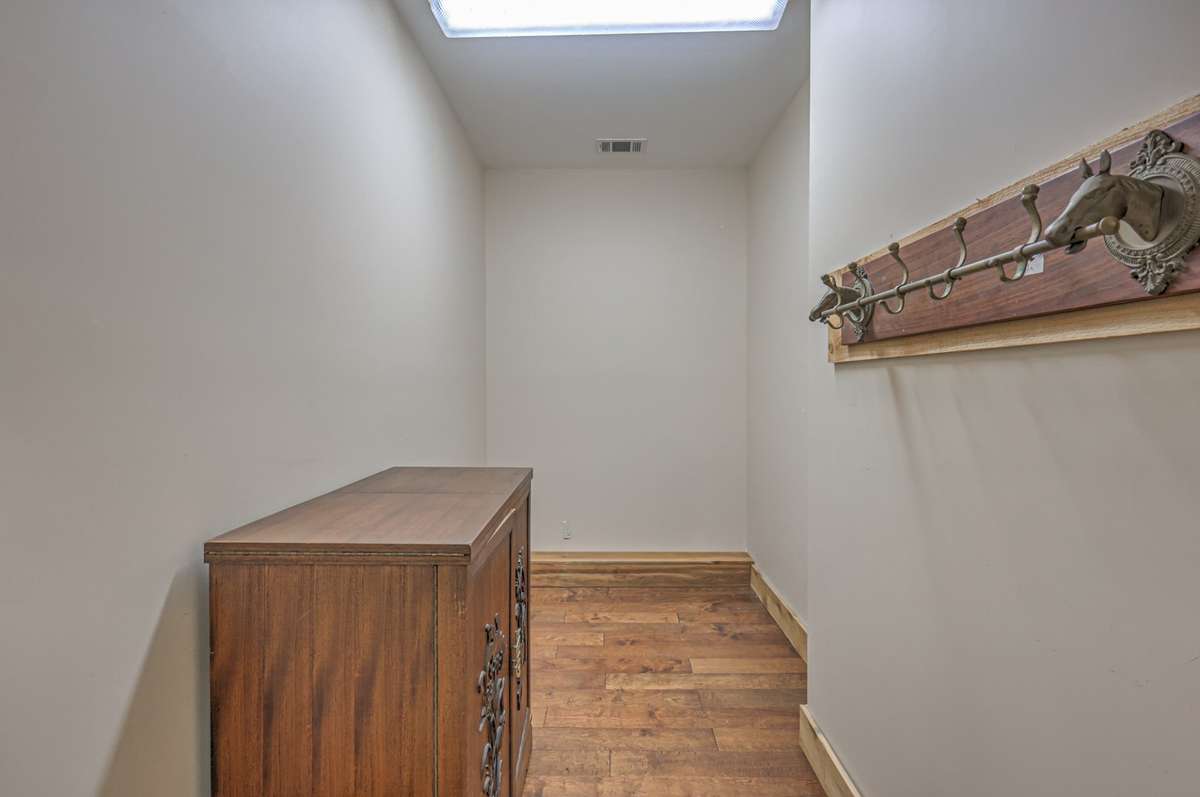Climate control tack room with hardwood flooring.