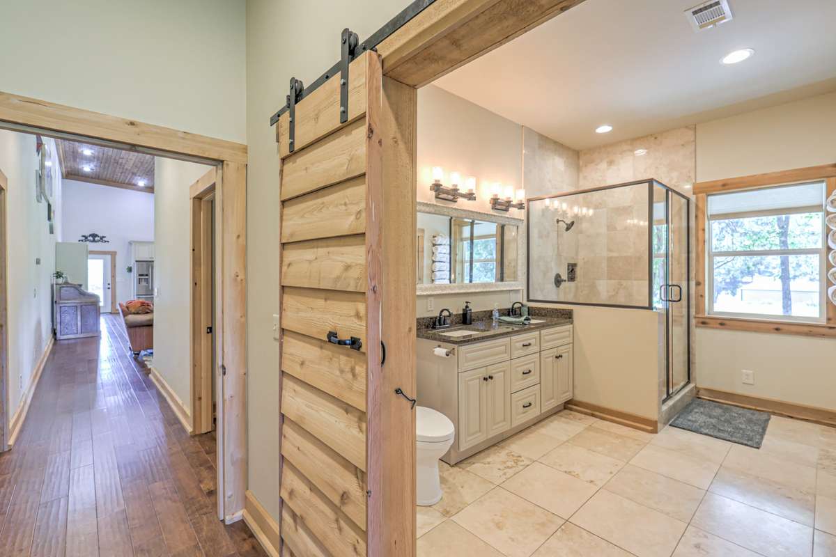 Master bath with granite counter tops and travertine flooring