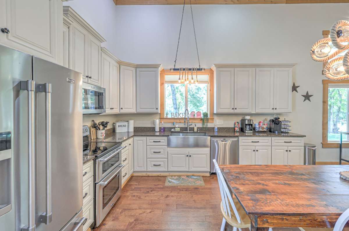 Kitchen has granite countertops, double oven and farm house sink.