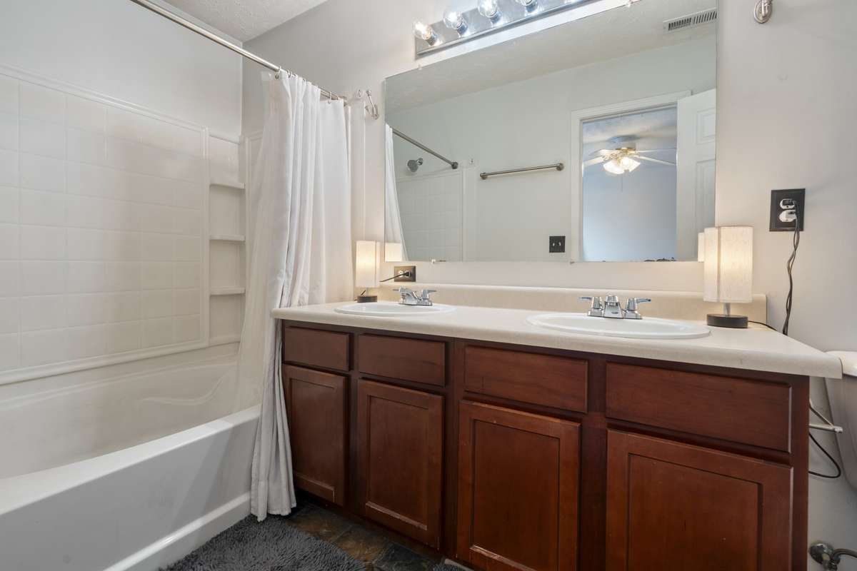 Complete with dual sinks, a tub and shower, and overhead lighting the primary bathroom has space for all your needs.