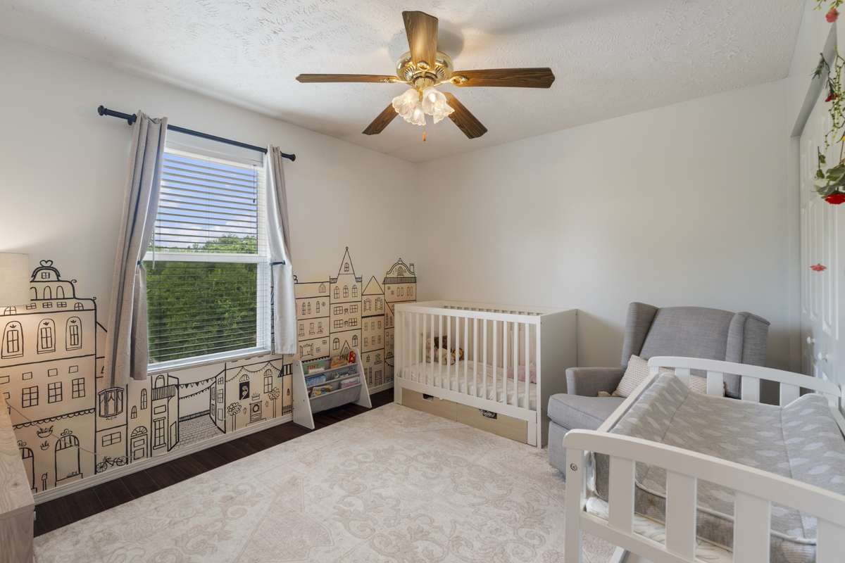 Upstairs you will find a large additional bedroom with a large window, ceiling fan for comfort, and a closet for keeping the space tidy.