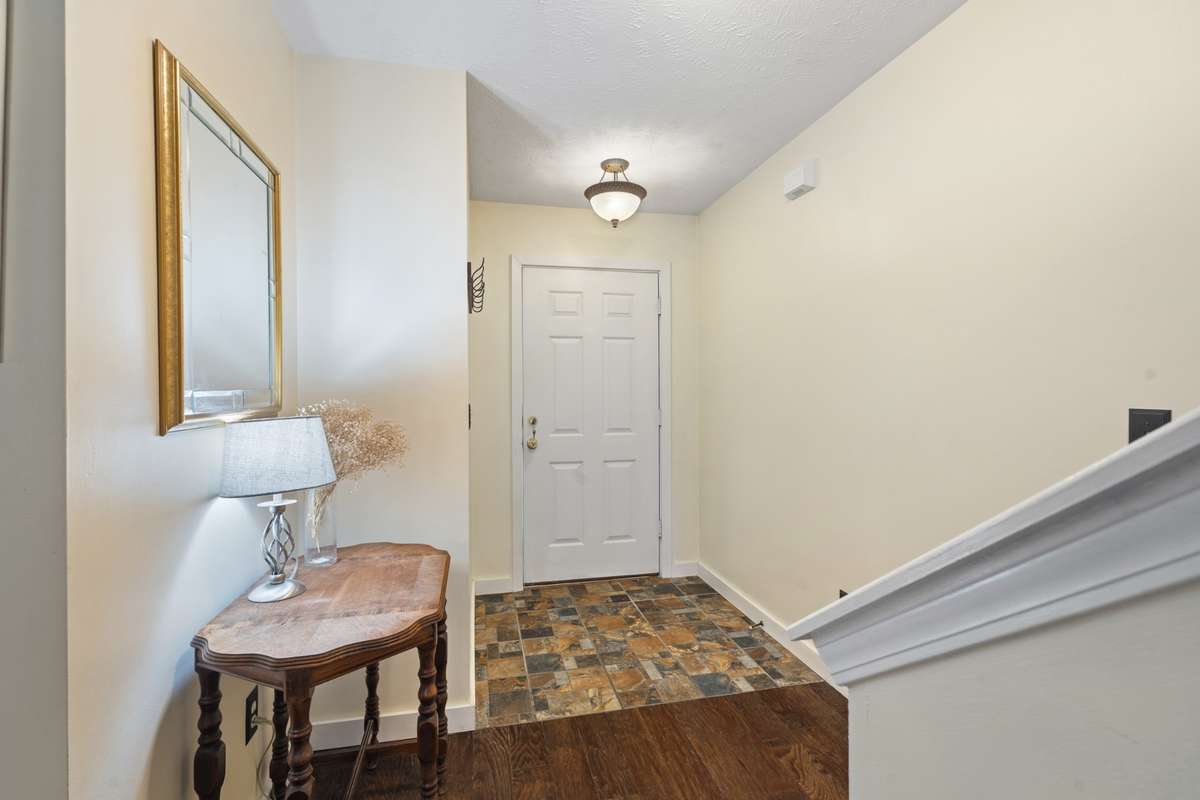 Walk into your entryway compete with an overhead light, quick access to the staircase, and updated flooring.