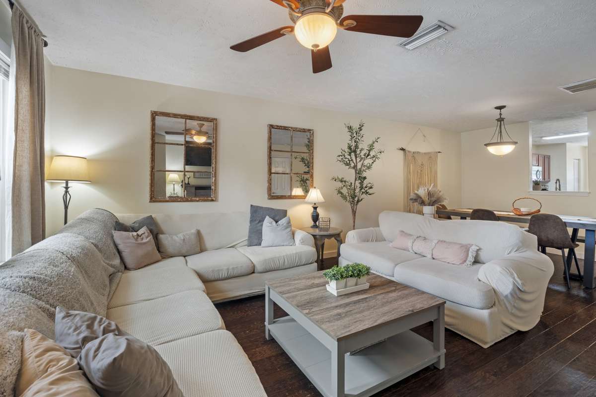 A large living area provides you with space to relax, unwind, or spend time with friends and family. Complete with an overhead fan, large windows, and beautiful hardwood floors.