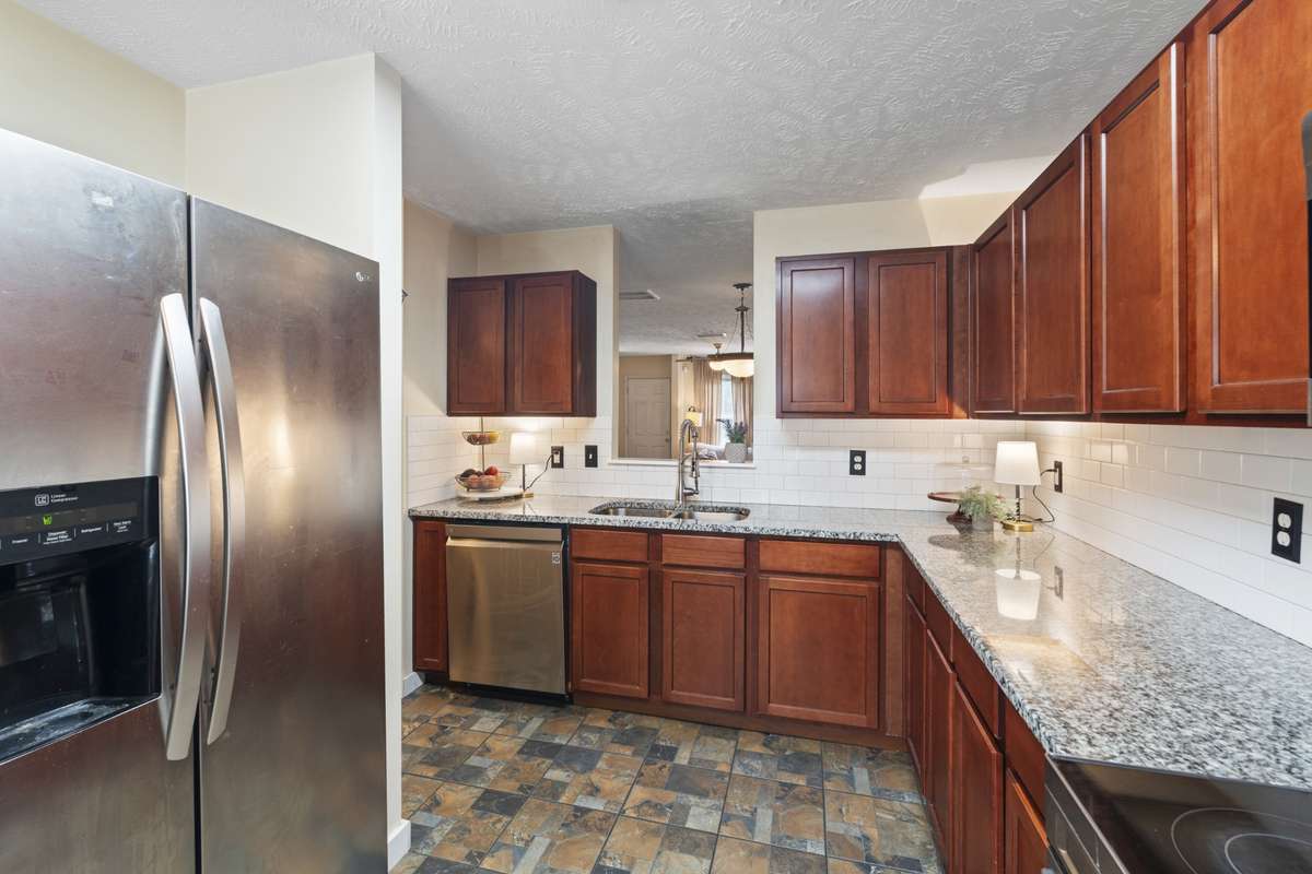 All SS appliances, subway tile backsplash, and unique flooring create an inviting kitchen space where you will enjoy prepping meals.