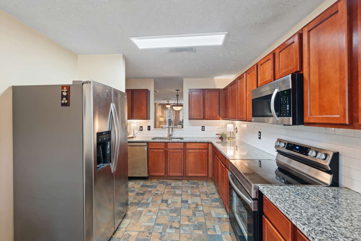 All SS appliances, subway tile backsplash, and unique flooring create an inviting kitchen space where you will enjoy prepping meals.