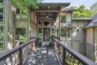 The long bridge-style entryway enhances the mountain retreat feeling.