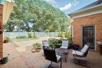 patio is nestled between screened porch, primary bedroom and great room.