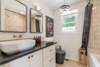 An outlet is located within the cabinetry of this beautiful designer bathroom