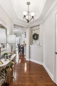 Light and bright foyer with crown moulding and trey ceiling. (previously staged)