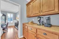 Coffee bar with TONS of storage sits between the kitchen and formal dining room.