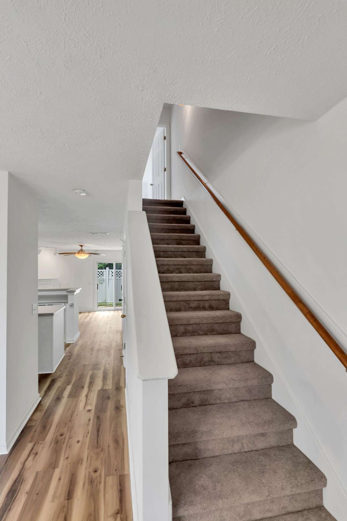 Staircase to 2nd level and a sneak peek at the gorgeous new flooring downstairs.