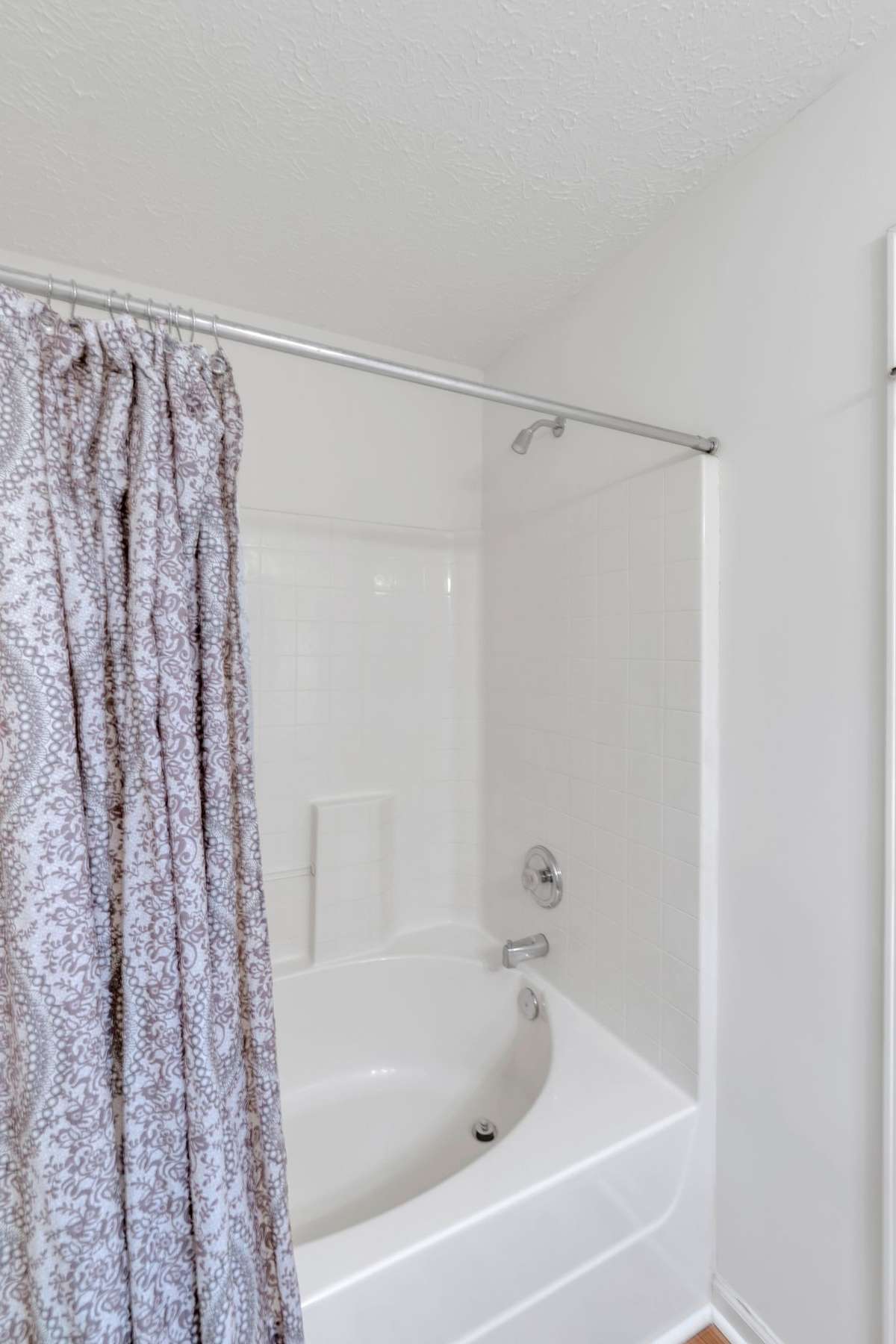 Beautiful, bright and shiny white tile surround.