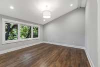 Upstairs bedroom with private bathroom and vaulted ceilings. (pic from prior listing)