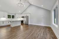Open kitchen to living area complete with warm hardwood floors and tons of natural light! (pic from prior listing)