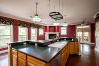 Pull out drawers, pot rack, tiffany style lighting, double doors to deck for easy grilling. Farm size sink. Pan rack remains