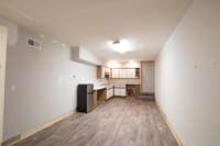 Basement kitchenette and game room. Easily be an exercise or TV room.