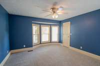 Bay window in primary, 2 walk in closets, ceiling fans and a luxurious bath.