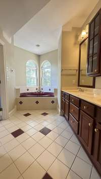 Tile floors in all baths. Super tall ceiling. Primary tile bath floor is heated.
