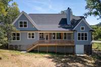 Covered deck plus outdoor deck!  Note the mower storage area with a concrete pad!