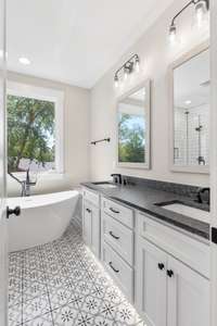 The owner's suite bath with double vanities and toe-kick lighting.