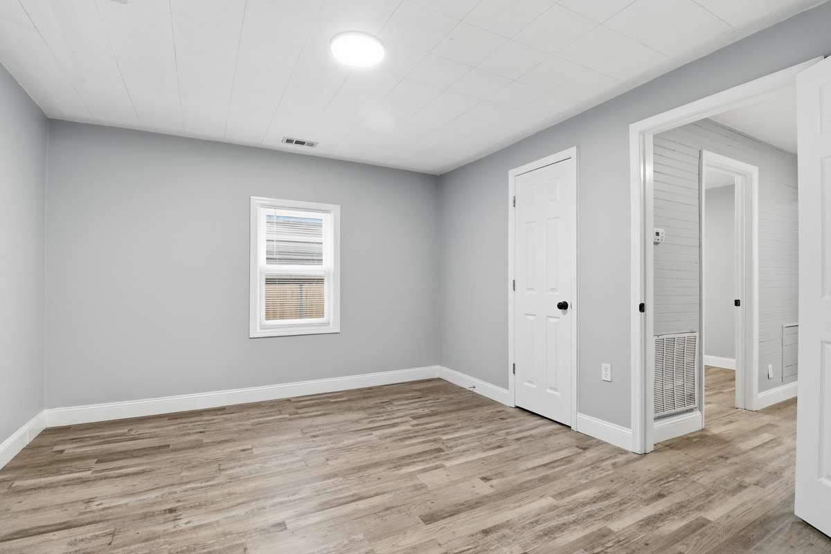 The front bedroom has new windows, now light, new sheetrock, fresh paint, new doors and new LPV luxury flooring.