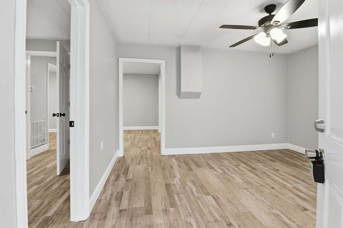 Welcome to 612 Maple Street. Walk into the Living Room with new LVP flooring, new ceiling fan, new sheetrock, fresh paint, new windows and new trim