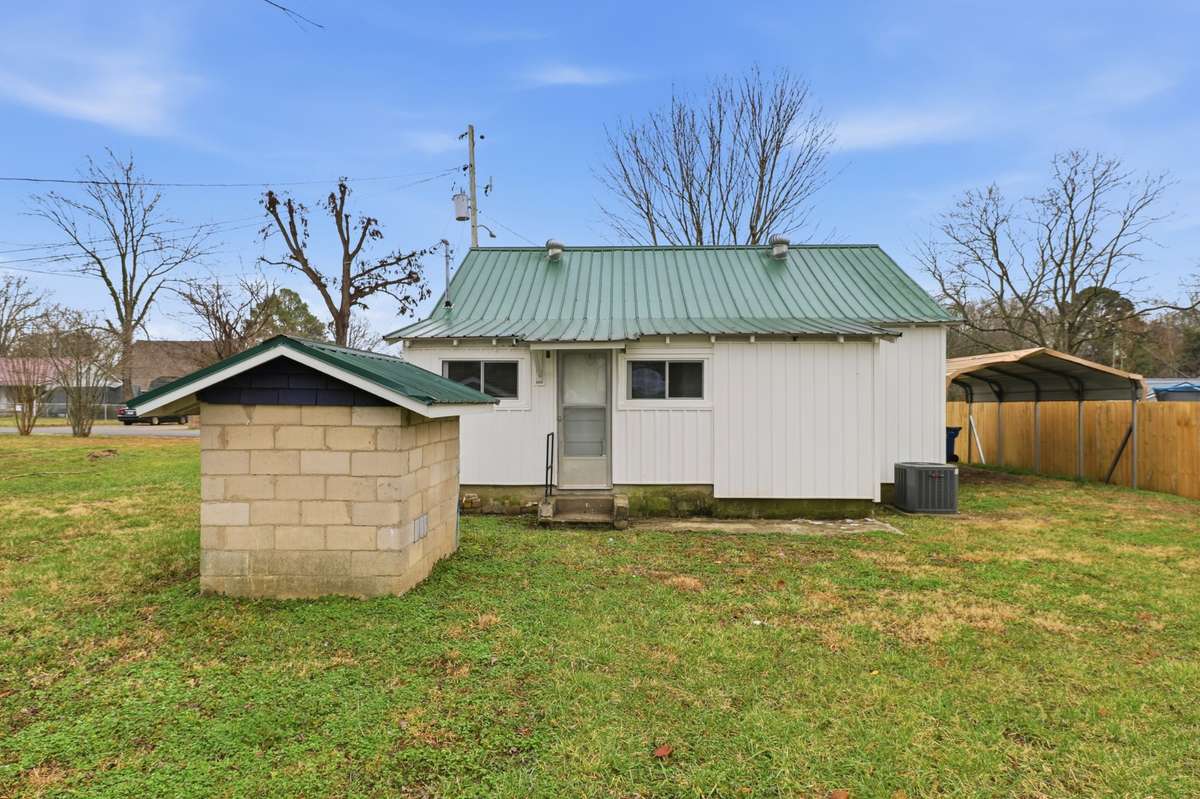 Back of the home with metal roof and new HAVC