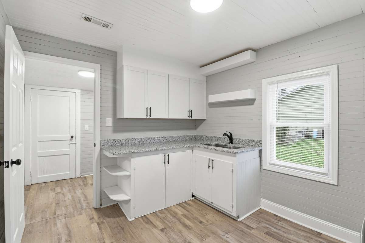 This angle shows some of the original charm with the shelves at the end of the cabinets. New windows, new shelves, upper cabinets, new light, paint and more