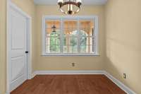 This room off the laundry room and kitchen could be a dining area or a reading/coffee nook. The next photo has been virtually staged.