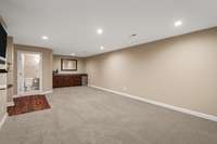 DOWNSTAIRS is this spacious flex space that includes both a wet bar and a full bathroom. Use this space however you desire, whether it's for entertaining, as a home theater, a great place for a pool table, or guest overflow.