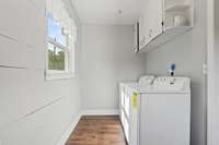 Convenient laundry room with cabinets.
