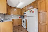 Kitchen with pantry cabinet.  All appliances stay, including the refrigerator!