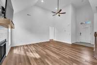 Bright + open living space with soaring ceilings and laminate floors.