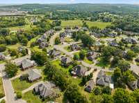 Drone shot showcasing the rear of the home and surrounding community.
