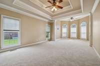 Retreat to the primary suite featuring new carpet and custom trim details.