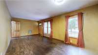 Huge living room with laminate flooring*Home has hvac but electric wall heaters are still present